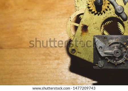 Wooden background with detail of a clock mechanism. gears of a mechanical watch
