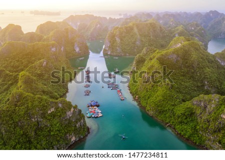 Aerial view of Cua Van floating fishing village and rock island, Halong Bay, Vietnam, Southeast Asia. UNESCO World Heritage Site. Junk boat cruise to Ha Long Bay. Famous destination of Vietnam