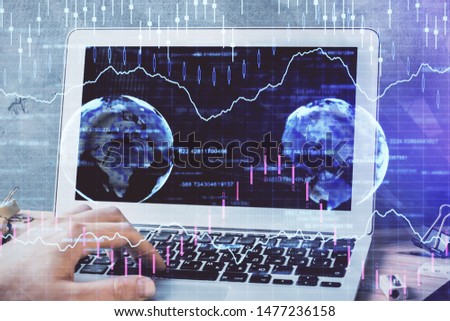 Forex graph with businessman working on laptop on background. Concept of hardworking. Multi exposure.