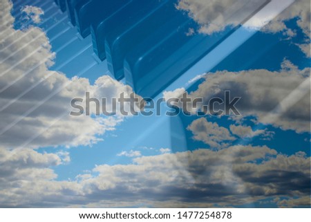 Piano keys on a background of blue sky with clouds. Music of the sky, melody of the clouds.