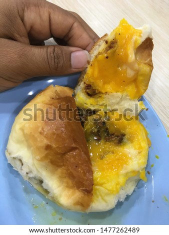 Bread open Inside this bread is jam with yellow color mixing with nute. This Bruneian food are eaten at breakfast. Picture taken in Brunei Darussalam