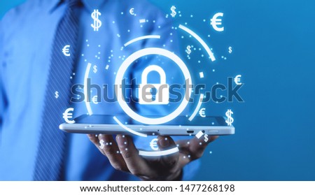 Man holding padlock with currency symbols. Financial security