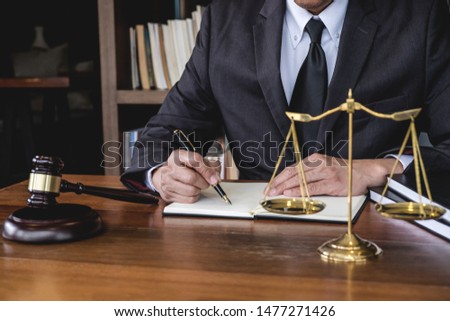 Legal law, advice and justice concept, Judge gavel with Justice lawyers, Counselor in suit or lawyer working on a documents in courtroom.