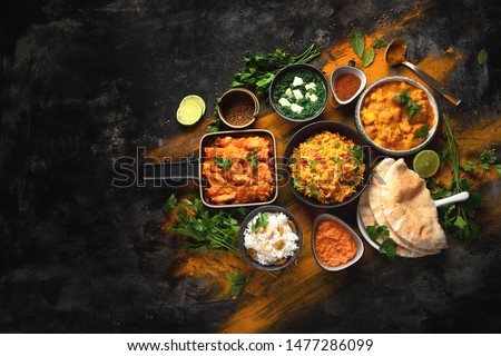Assorted indian food on black background.. Indian cuisine. Top view with copy space Royalty-Free Stock Photo #1477286099