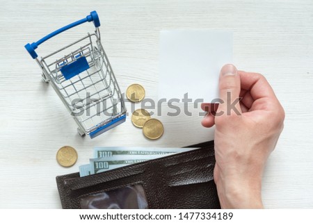Shopping list mockup. Blank paper page, wallet and shopping cart on a white background.