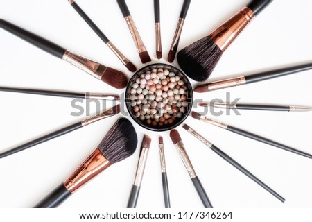 
Makeup brushes and powder, forming a circle on a light background. Horizontal template for make-up artist business card or flyer design.