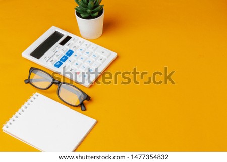 Stylish messy yellow desk top with various stationery top view