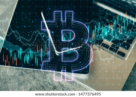 Blockchain concept with bitcoin sign at forex chart background and laptop with notebook. Double exposure.