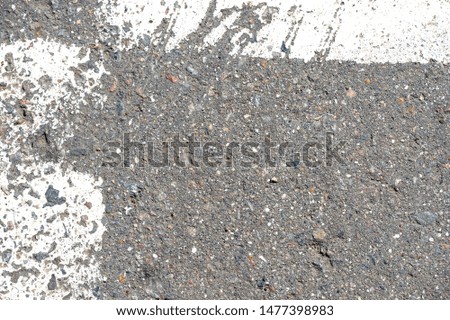 Old dirty asphalt texture with white paint on it. Top view