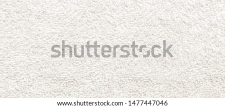 white fabric and texture concept - close up of a towel terry cloth Royalty-Free Stock Photo #1477447046