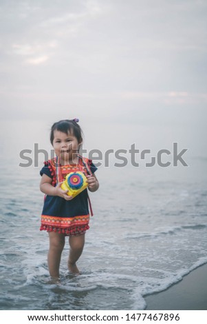 Asian kids playing on the beach