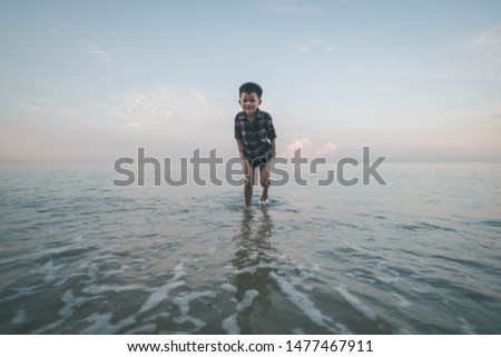 Asian kids playing on the beach