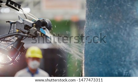 Worker man control Robot Machine Tool that is processing Fiberglass with Model for composite FRP products Royalty-Free Stock Photo #1477473311