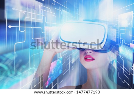 Astonished young woman in VR glasses looking at social media and video streaming service interface. Concept of future technology. Toned image double exposure blurred