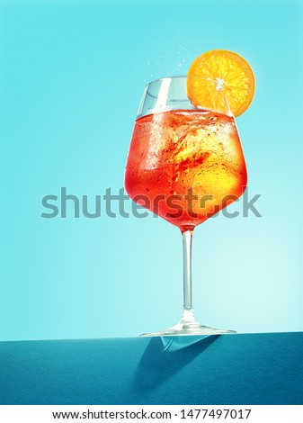 Glass of Aperol spritz cocktail on blue background Royalty-Free Stock Photo #1477497017
