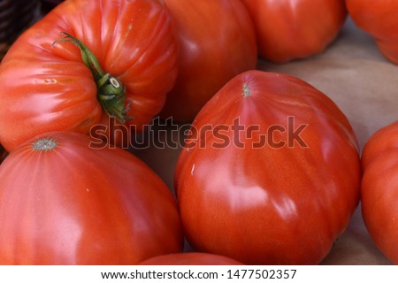 close up picture of organic tomatoes for sale on a market stall. Very tasty vegetable compare to industrial production.