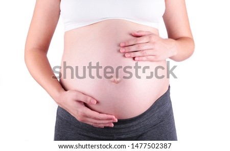 A cute pregnant belly isolated on white, pregnancy concept