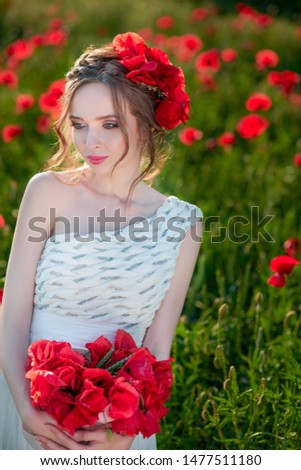 Beautiful women in a poppy field at sunset. Girl in a field of poppies with box of poppies flowers in white dress. Beauty Girl Outdoor. Freedom concept.
Close up portrait.