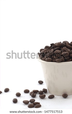 Coffee beans pile in pot or bowl and on the ground with shadow and white isolated in half picture