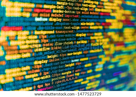 Close up of computer web page code inside of html file. Mobile app developer. Modern technologies, web cascading design. Simple website HTML code with colorful tags in browser view on dark background