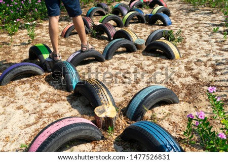 Recycle tire wheel on playground,paint the color for running on tires,outdoor exercise to  balancing act.Concept create value from the waste.