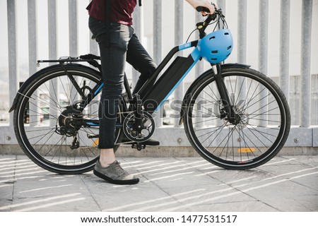 Urban cyclist taking a brake on e-bike