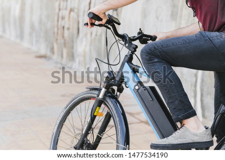 Close up man riding an e-bike