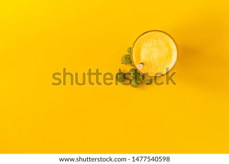 top view of a summer cool smoothie drink on a color surface with copy space