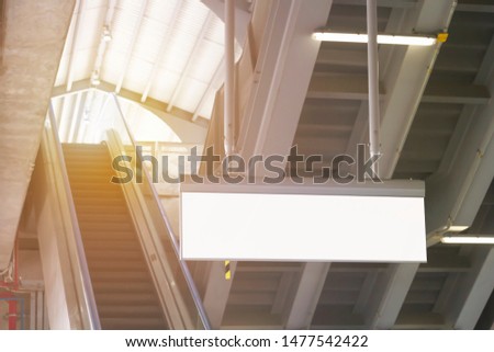 Blank signboard horizontal in subway station with escalator background. It is direction signage mock up for information public transport.