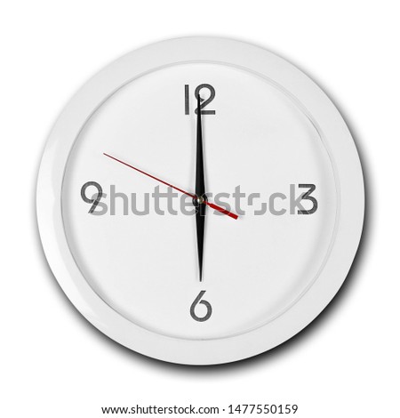 Large round white wall clock with white frame. The hands point to 6 o'clock. Close up. Isolated on white background.