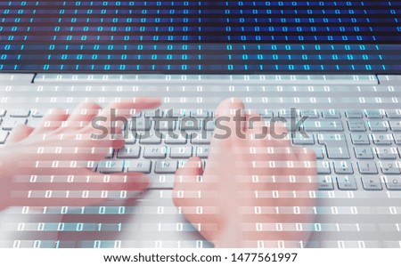 Close up of female blured hands typing on laptop keyboard with binary code