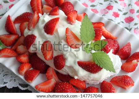 Dessert with strawberries, whipped cream and meringue.