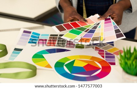 Design Studio. Closeup Of Black Female Hands Choosing Color Samples In Fashion Atelier. Selective Focus