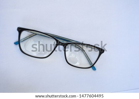 A pair of reading glasses on a white background.