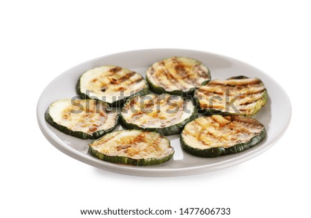 Plate of grilled zucchini slices on white background