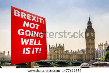 Placard with anti-Brexit message with Big Ben and Houses of Parliament, London in background Royalty-Free Stock Photo #1477611359
