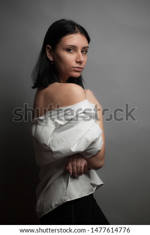 Portrait of young woman with bare shoulders. Studio