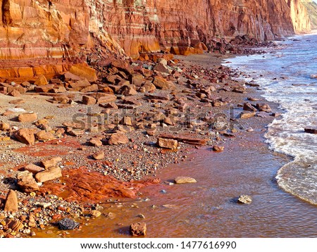        Sea erosion along the defenceless triassic cliffs on the Jurassic Coast in Devon, England after a winter storm.                        