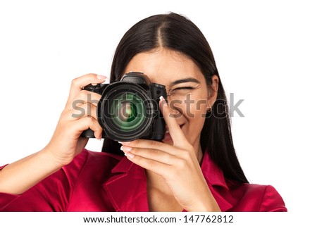 Young cheerful woman taking a picture over white background 