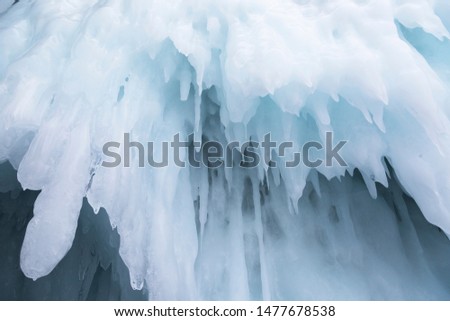 Huge icicles in the ice grotto on Lake Baikal in winter, Siberia, Russia