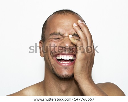Portrait of a Laughing Man with his hand on his face Royalty-Free Stock Photo #147768557
