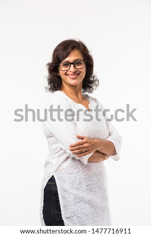 Indian Mid age women/lady's portrait, standing isolated over white background Royalty-Free Stock Photo #1477716911