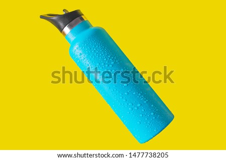 top view thermos water bottle. Blue water bottle wet isolated on yellow background Royalty-Free Stock Photo #1477738205