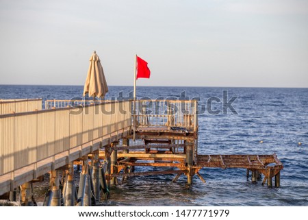Red flag warning sign no swimming
