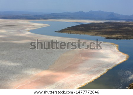 Aerial view of the salt pan and mineral crust with red algae of Lake Magadi, Great Rift Valley, Kenya. In the dry season is 80% covered by soda. It’s known for its wading birds and flocks of flamingos