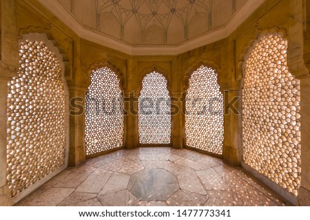 Perforated wall in the building of the palace in the Amber Fort at Jaipur, India. Royalty-Free Stock Photo #1477773341