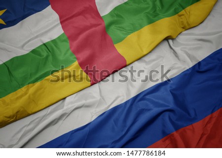 waving colorful flag of russia and national flag of central african republic. macro