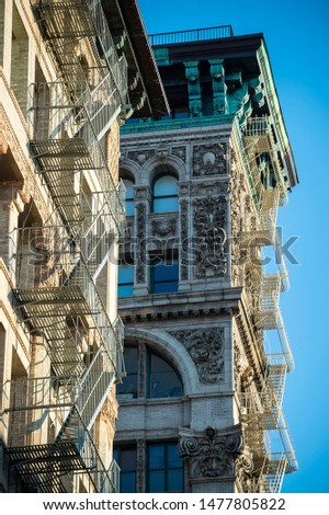 Bright sunny detail view of old Beaux-Arts Silk Exchange Building with ornate cornice features in downtown Manhattan, New York City, USA