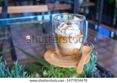 Italian coffee-based dessert, Pouring shots of hot espresso on vanilla ice cream to make an affogato coffee. A glass of coffee in cafe shop