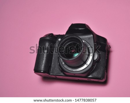 Digital Camera isolated on pink background. Photography equipment